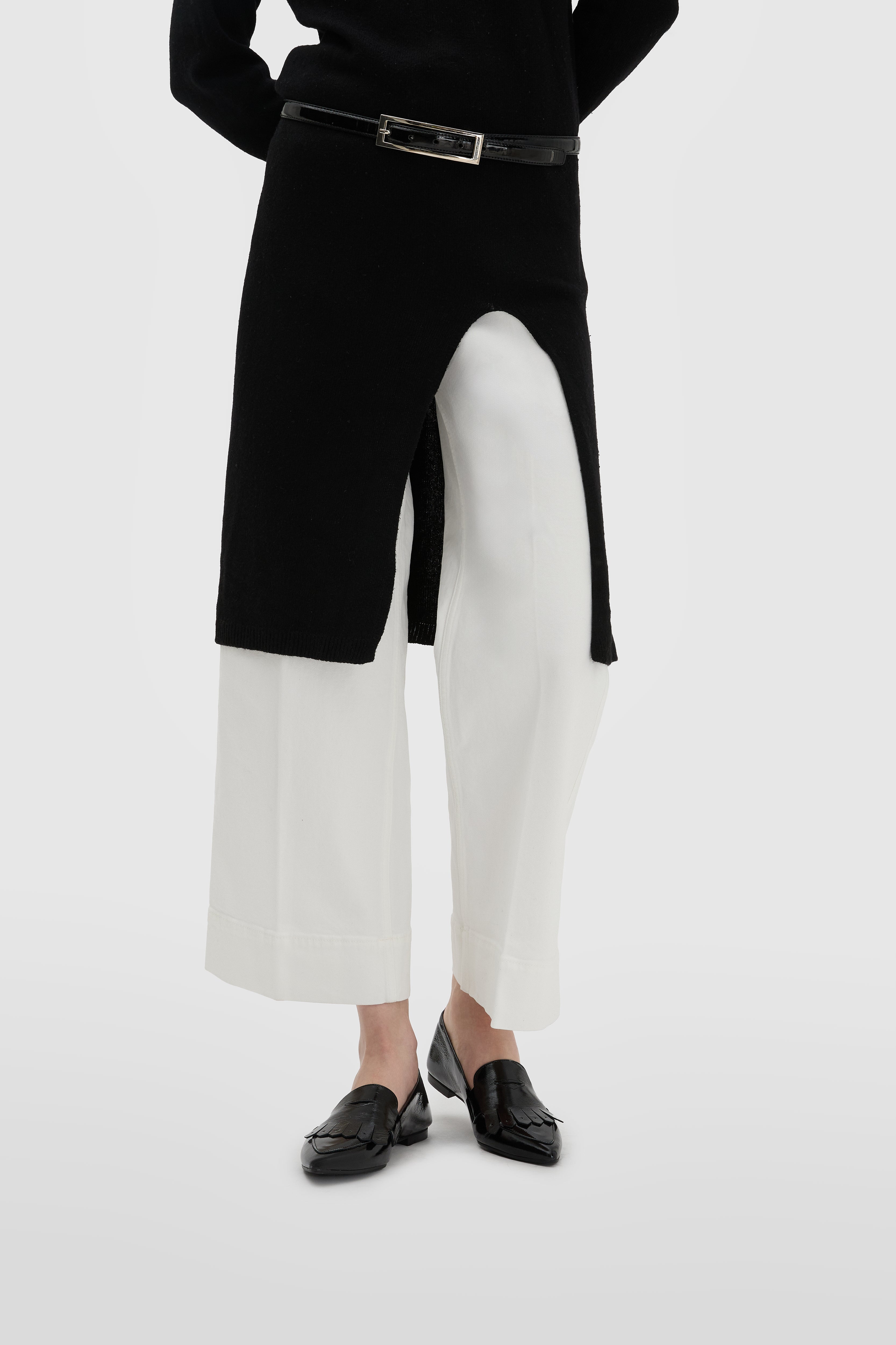 Black patent leather loafer with fringe and snap-eye mask