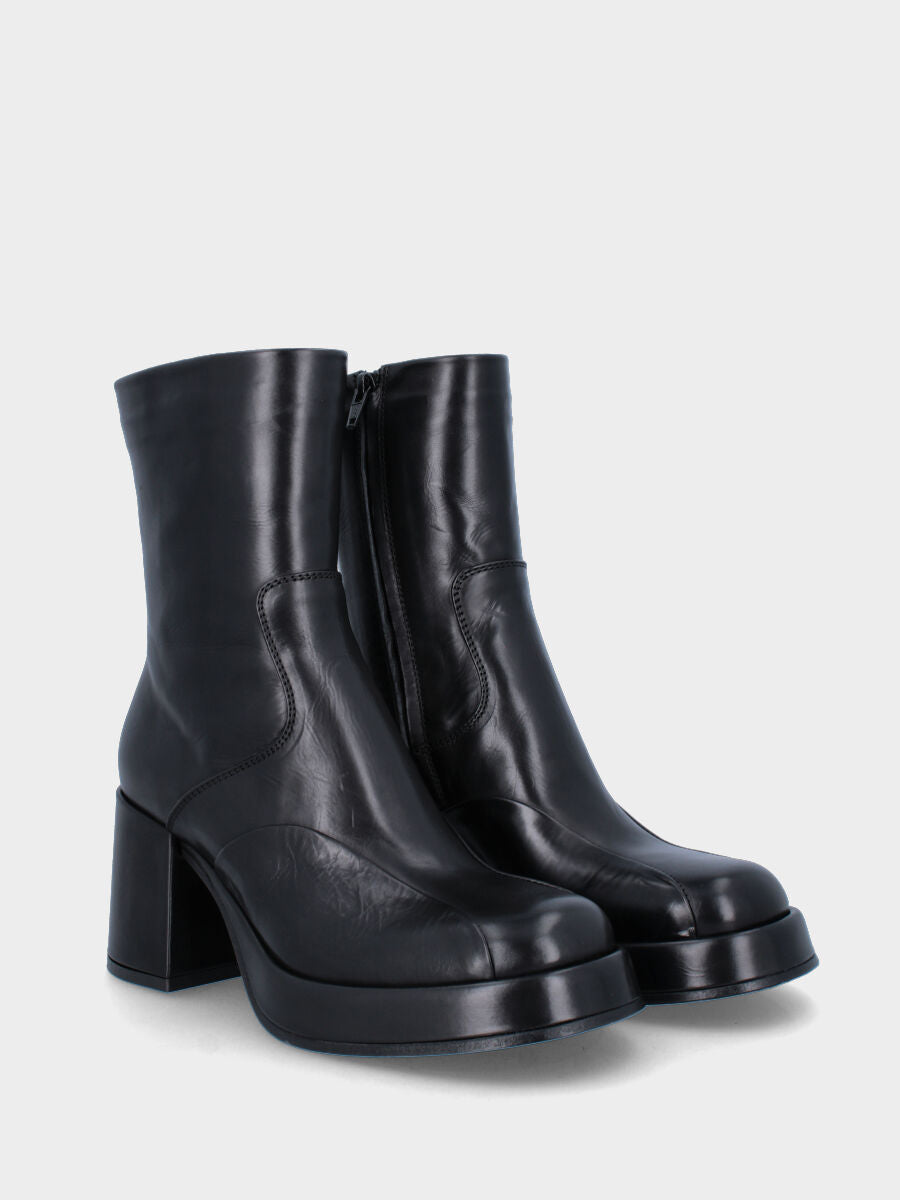 Black leather ankle boot with stitched joint mask
