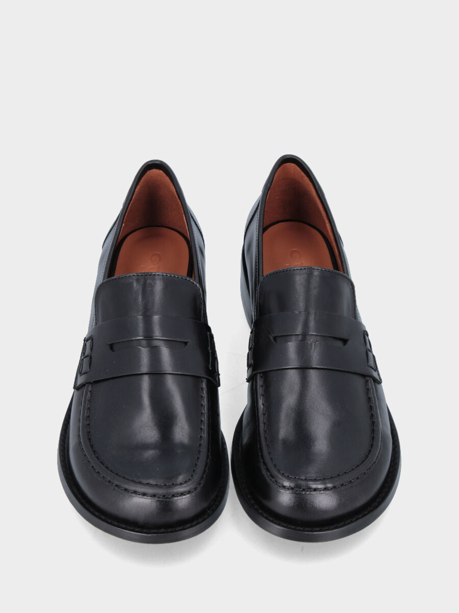 Mocassin en veau noir avec masque bouche de lion et semelle cousue