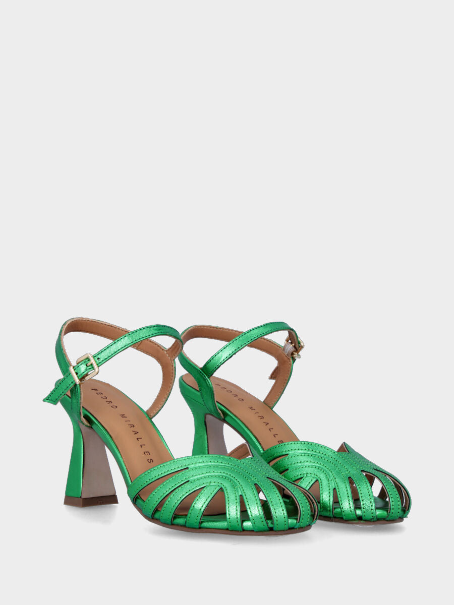 Green laminated sandal with straps on the sole
