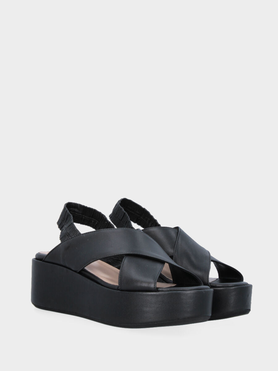Black leather sandal with crossed straps and wedge