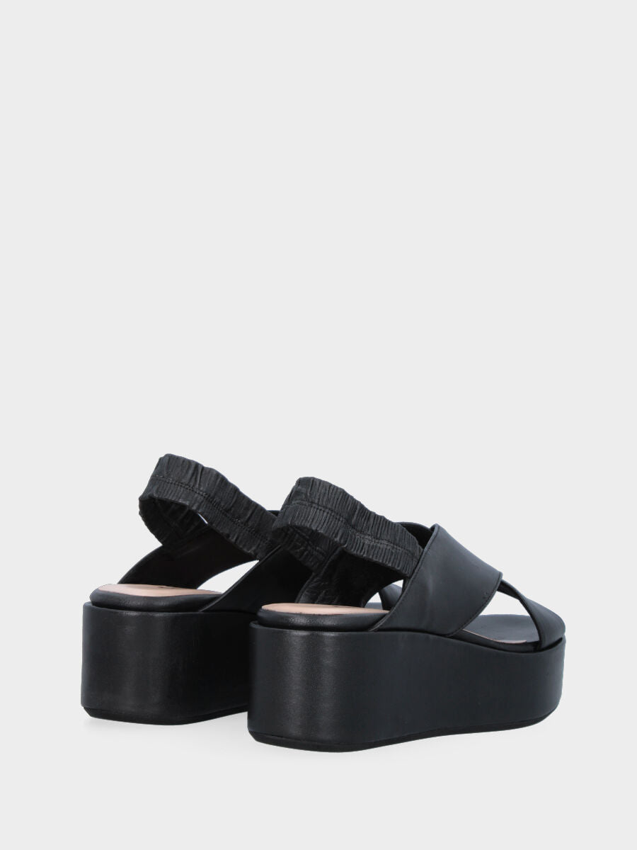 Black leather sandal with crossed straps and wedge