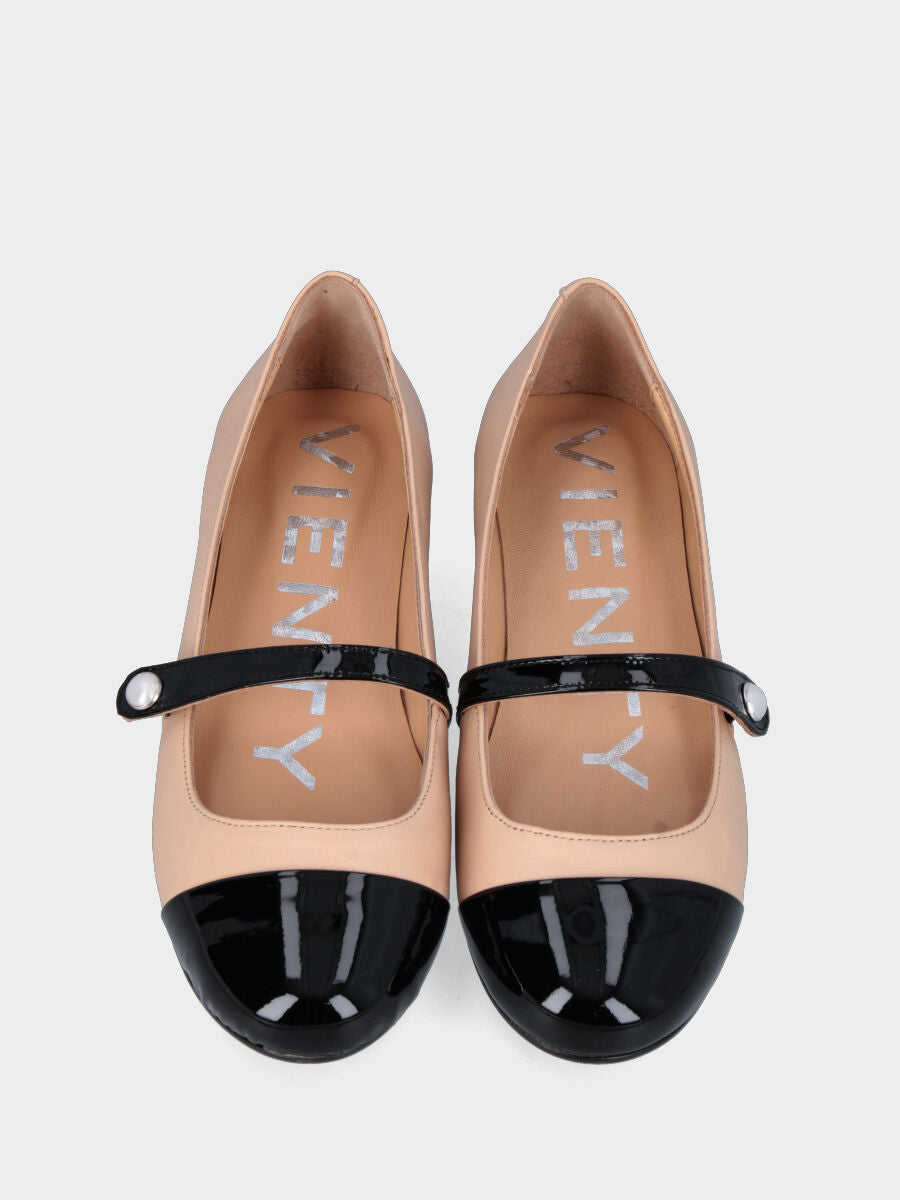 Beige leather ballet flat with black patent toe cap