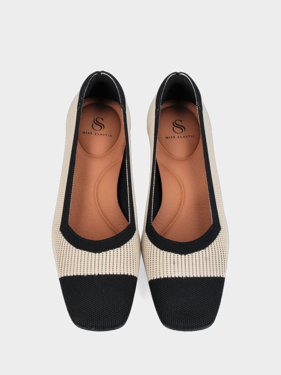 Décolleté in tessuto elasticizzato crema con profili neri e tacco a calice