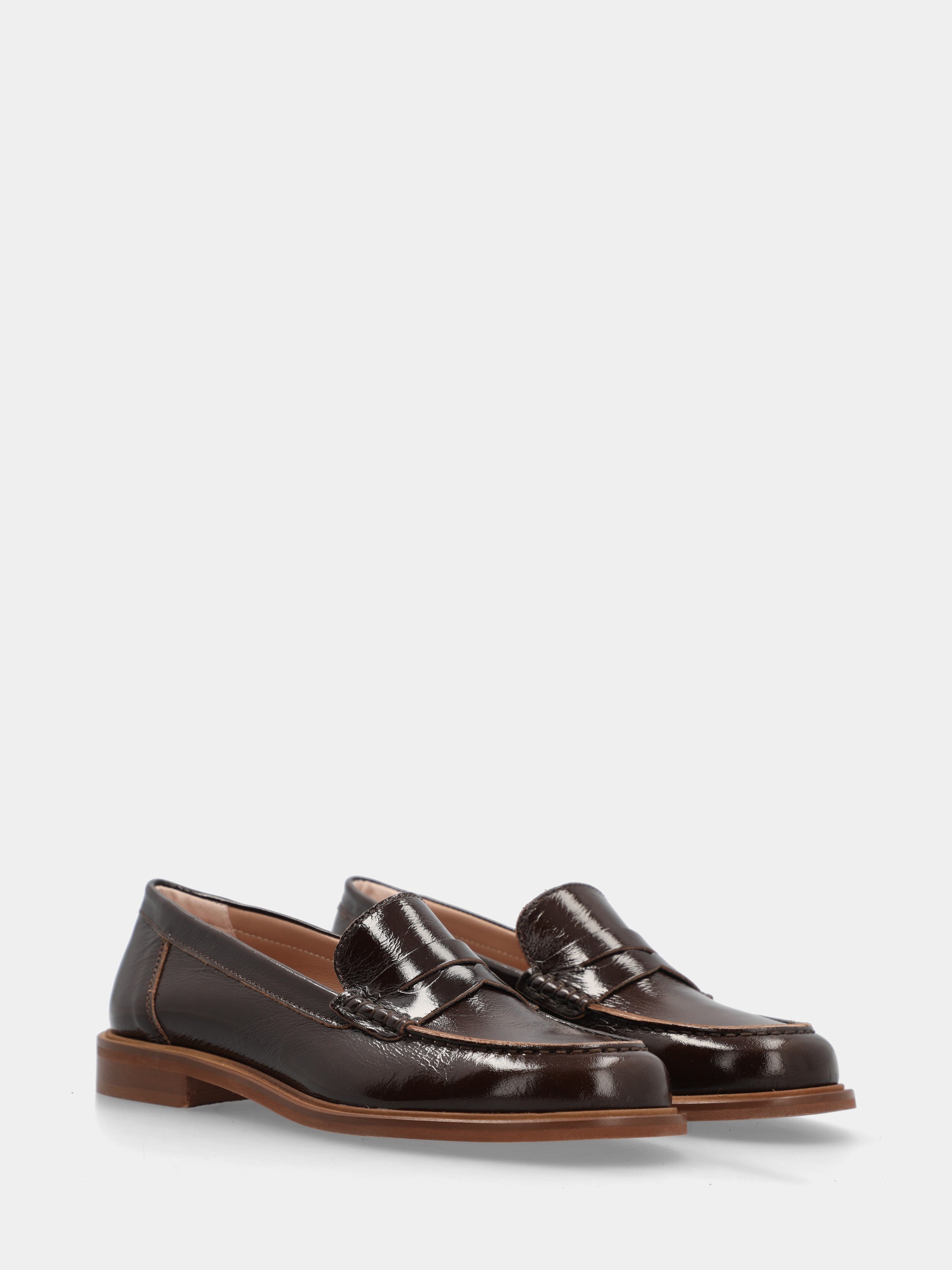 Dark brown patent leather loafer with lion mouth mask detail
