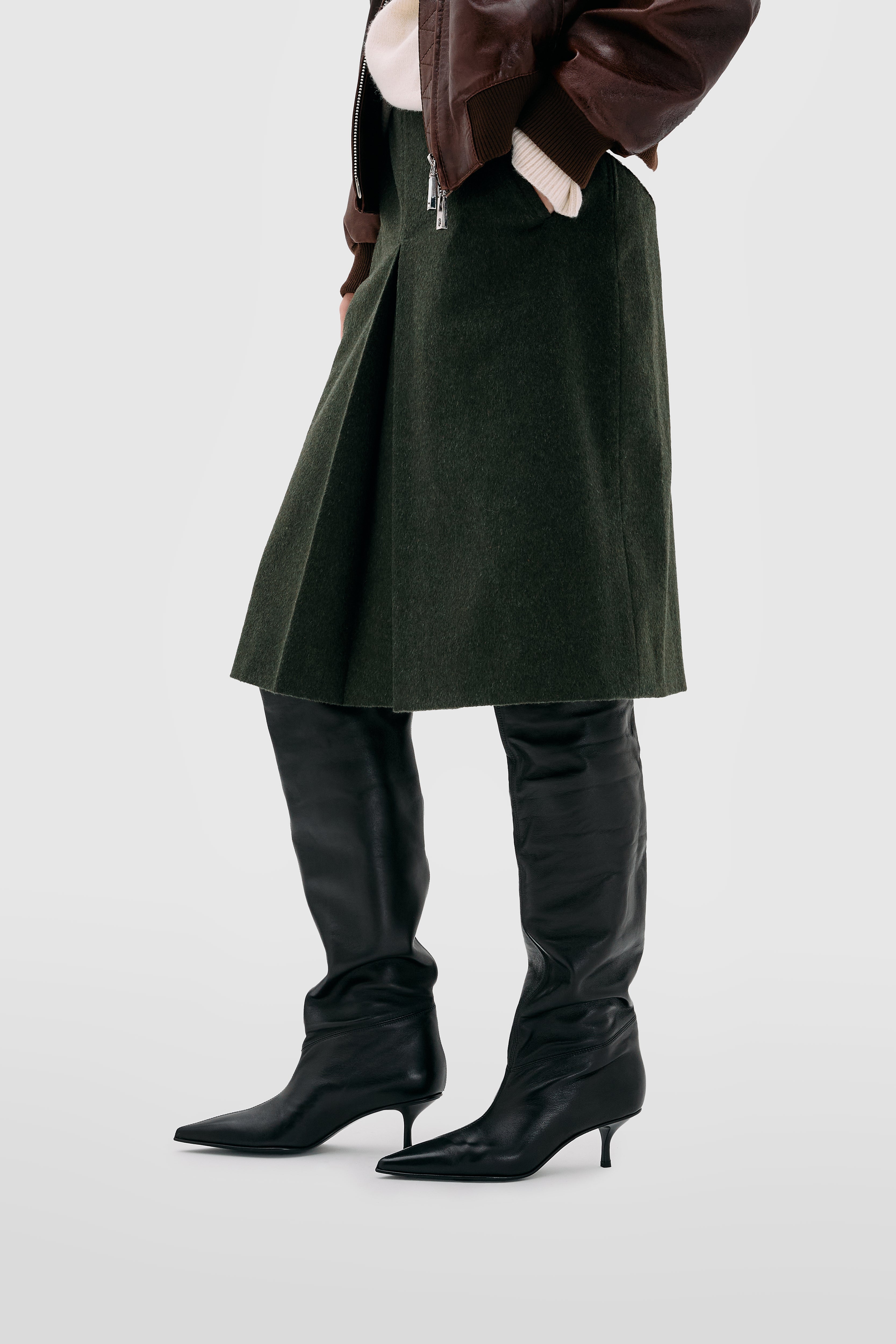 Black nappa leather tube boot with pointed toe and chalice heel