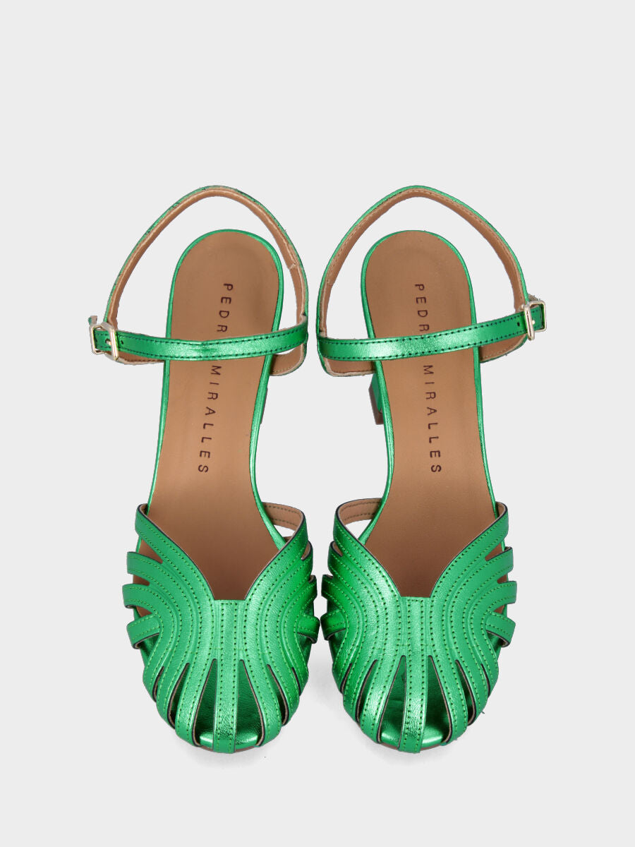 Green laminated sandal with straps on the sole