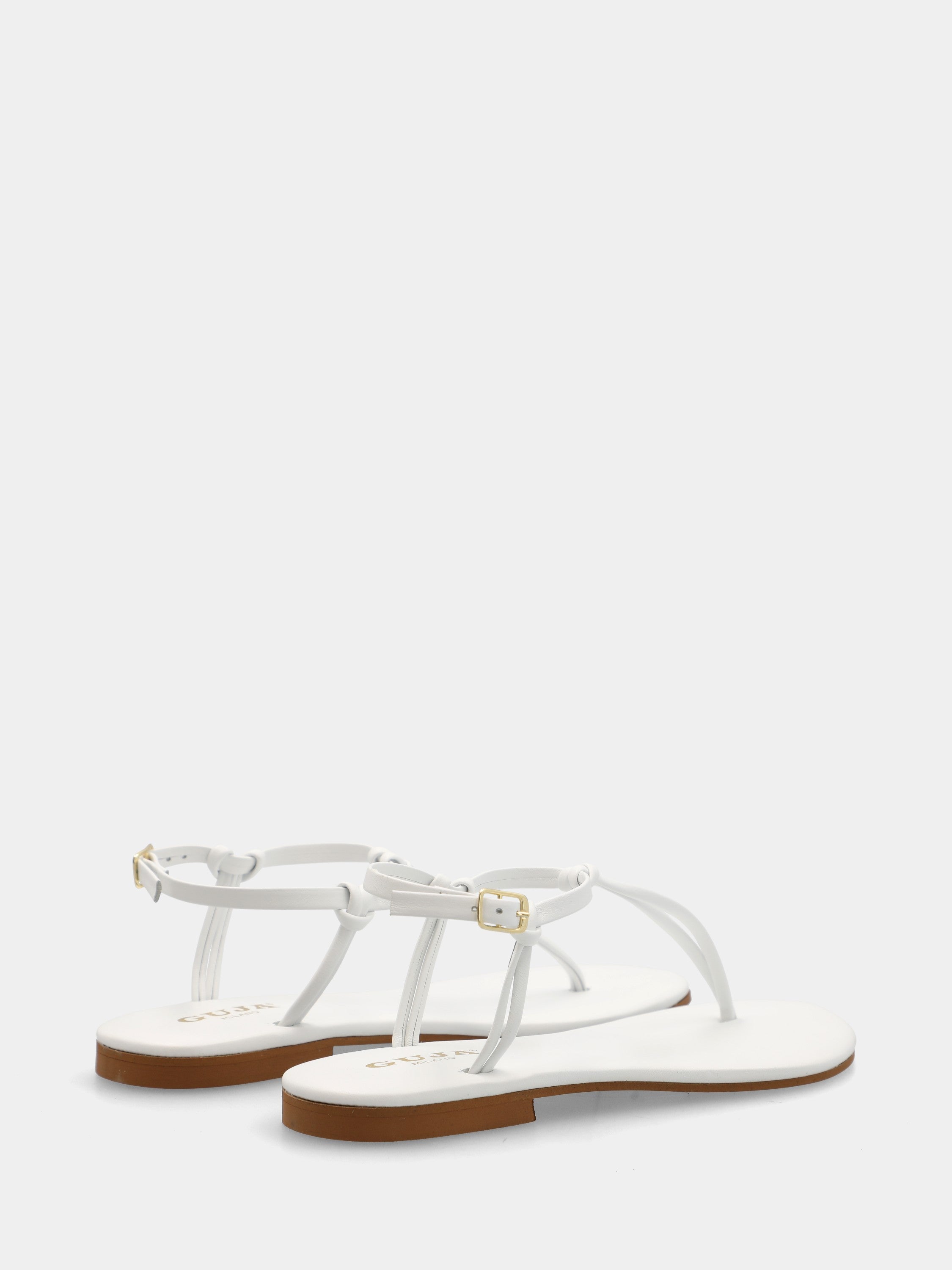 Tongs en nappa blanche avec lacets tubulaires et bride à la cheville