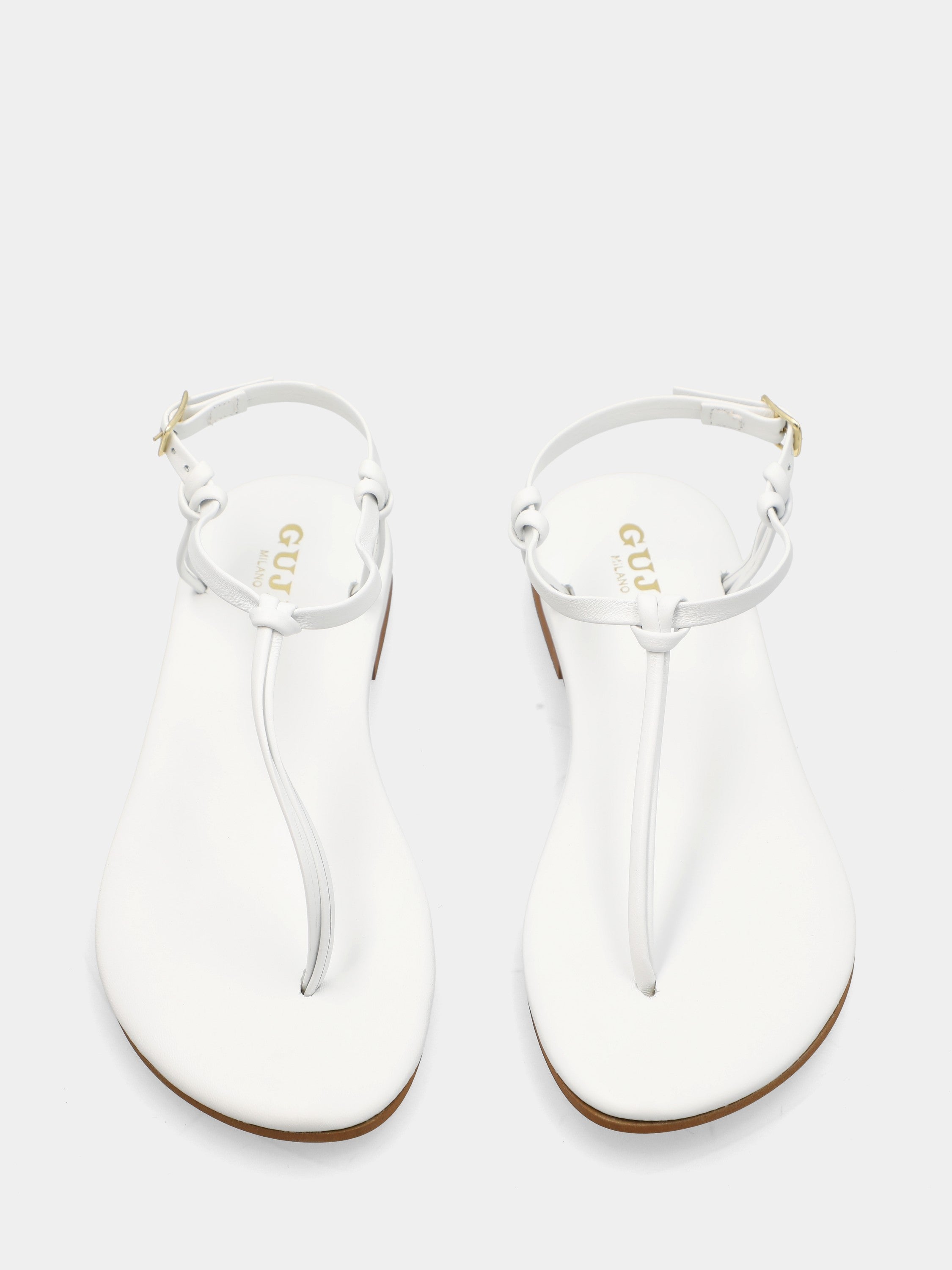 Tongs en nappa blanche avec lacets tubulaires et bride à la cheville