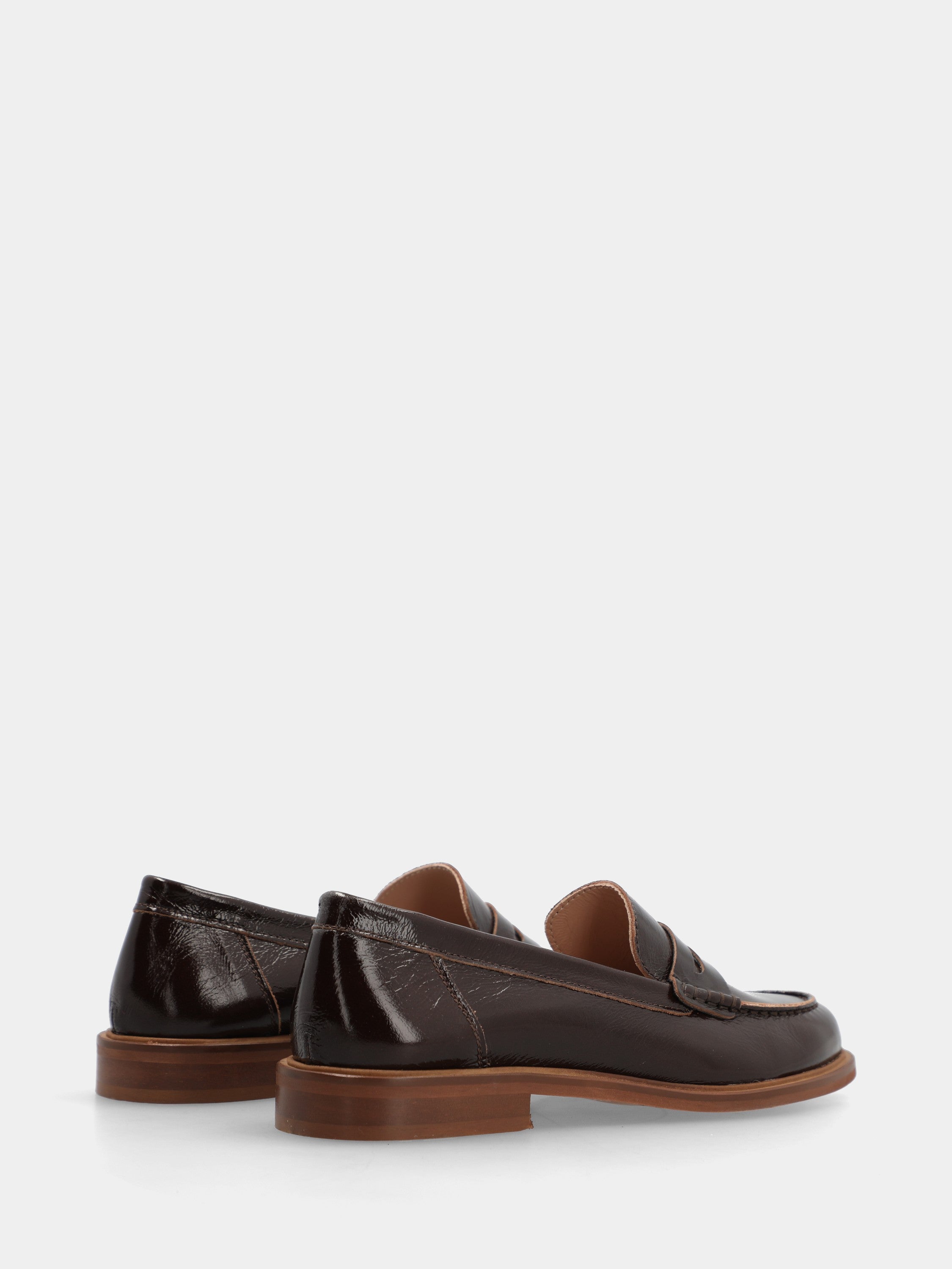 Dark brown patent leather loafer with lion mouth mask detail